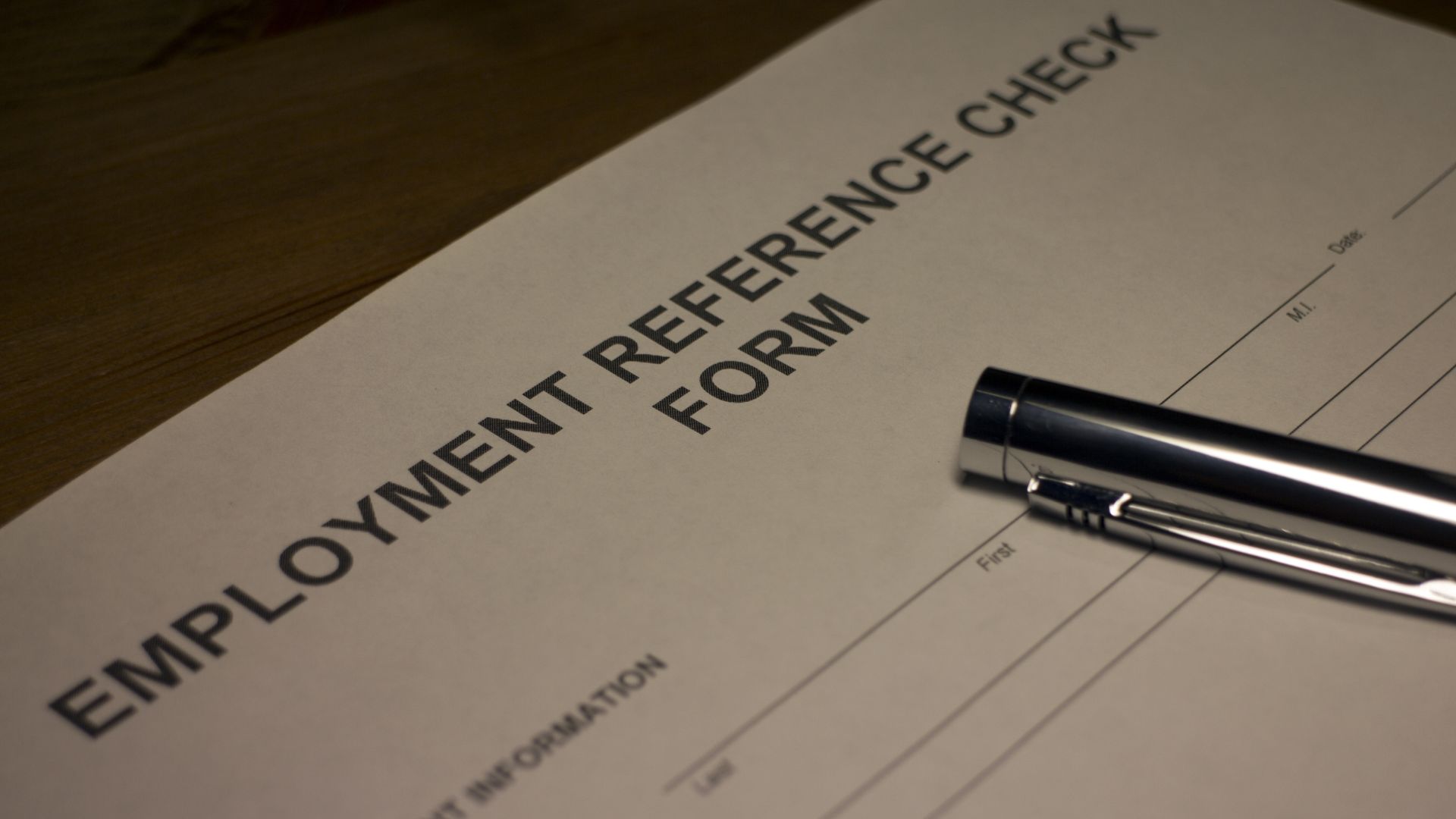 A job reference form with a pen
